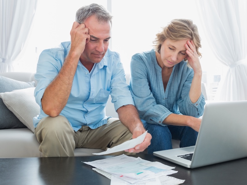 Concerned American couple in their 50s reviewing retirement savings amid economic pessimism in 2026